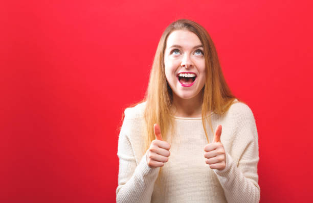 istock Happy young woman giving thumbs up 945343932