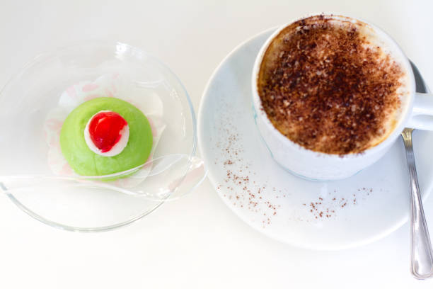 chocolate almond cake and cup of coffee on wood table