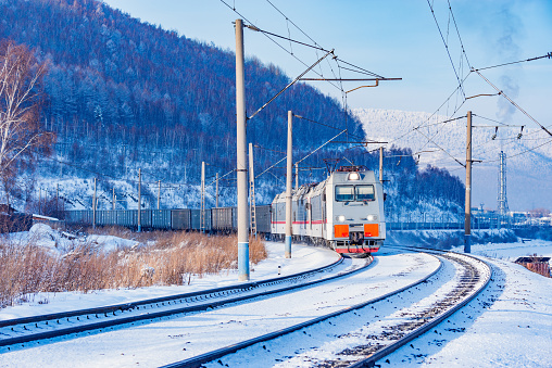 Freight train moves along Baikal lake. Trans Siberian railway. Russia.