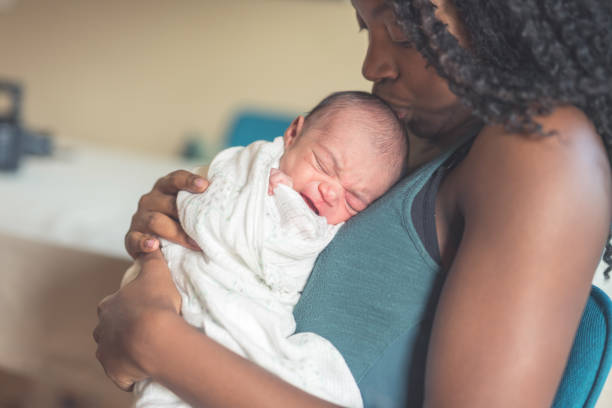 istock New mom holds her infant daughter 945344624