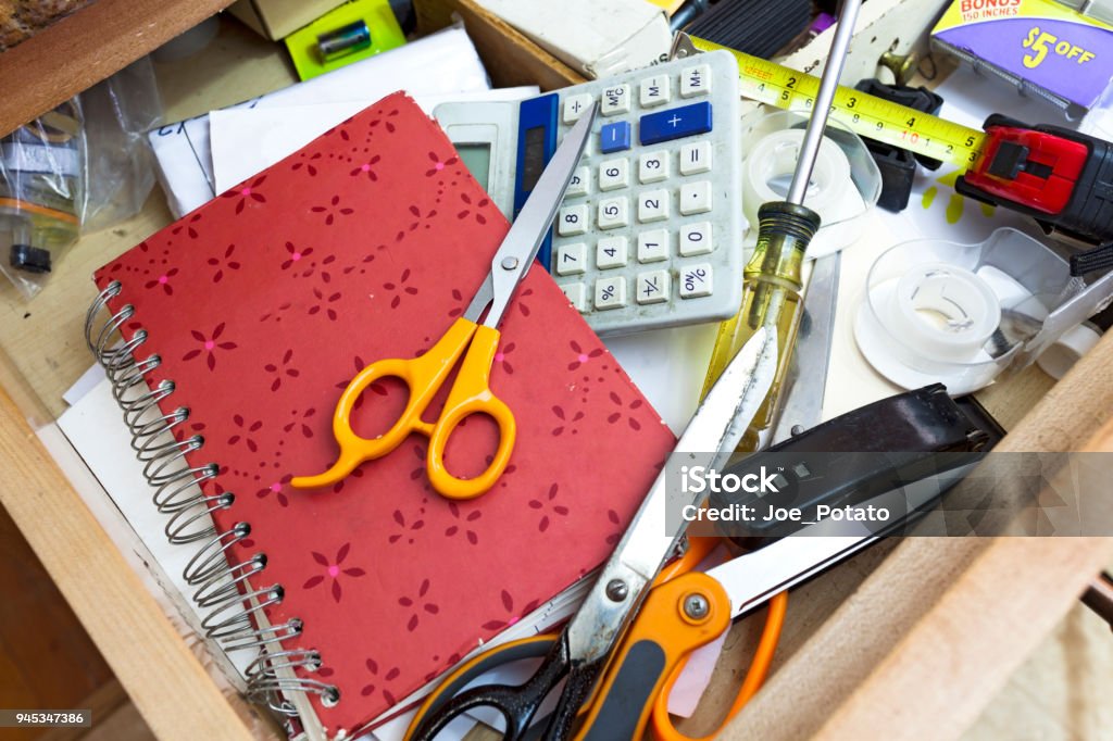 Drawer Clutter Cluttered kitchen drawer filled with a confusing jumble of everyday objects. Drawer Stock Photo