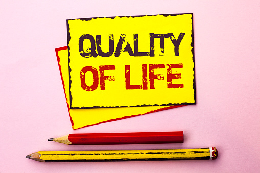 Text sign showing Quality Of Life. Conceptual photo Good Lifestyle Happiness Enjoyable Moments Well-being written Yellow Sticky Note Paper the Pink background with Pencil next to it.