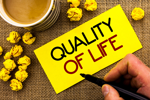 Text sign showing Quality Of Life. Conceptual photo Good Lifestyle Happiness Enjoyable Moments Well-being written Sticky Note Paper the jute background Cup and Paper Balls next to it.