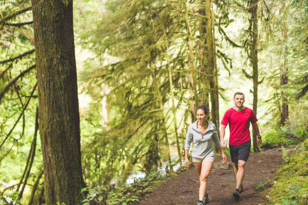 istock Couple running in the forest 945350664