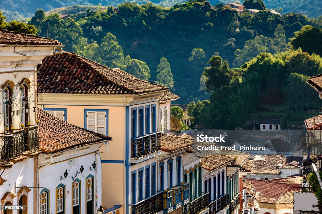 Facade of some old houses built in colonial architecture Facade of old houses built in colonial architecture with their balconies, roofs and colorful details in the historical city of Ouro Preto in Minas Gerais. Ancient Stock Photo