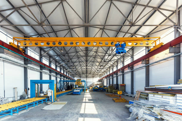 istock Industrial manufactory workshop for production sandwich panels for construction. Modern manufacturing storage factory interior 945370244