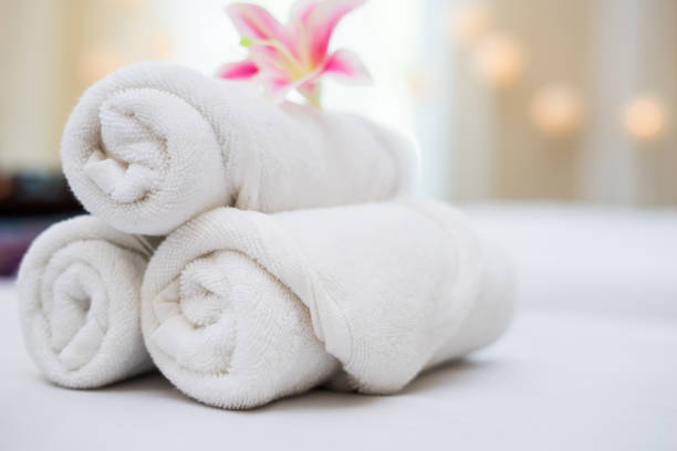 istock beautiful pink orchid on white towel in spa salon. 945372698