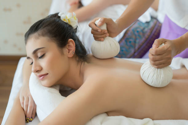 istock Young beautiful woman relaxing during massage in spa salon. 945373682