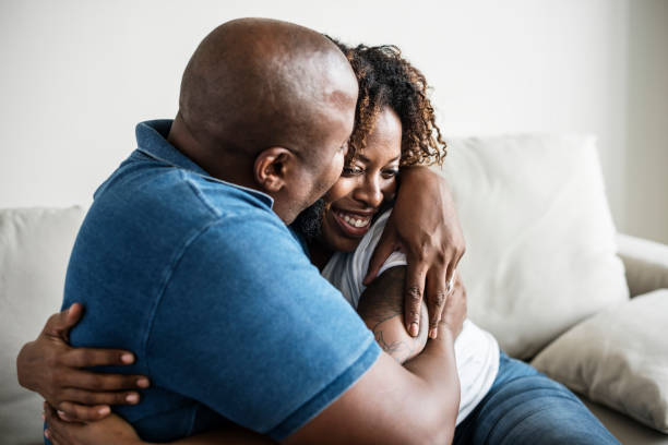 istock A cheerful black couple on a sofa 945374456