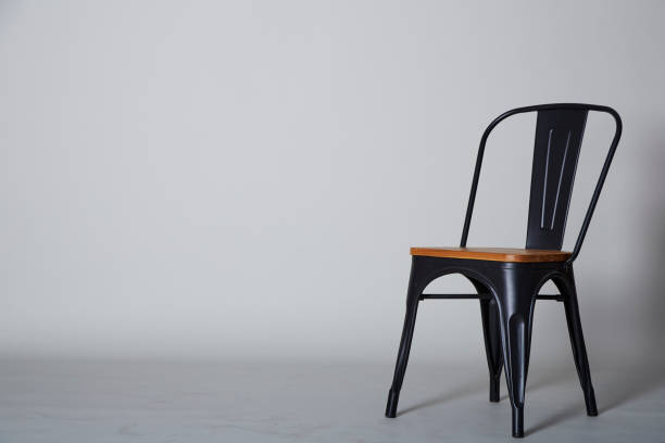istock Steel with wood chair on Grey  textured background wall 945383772