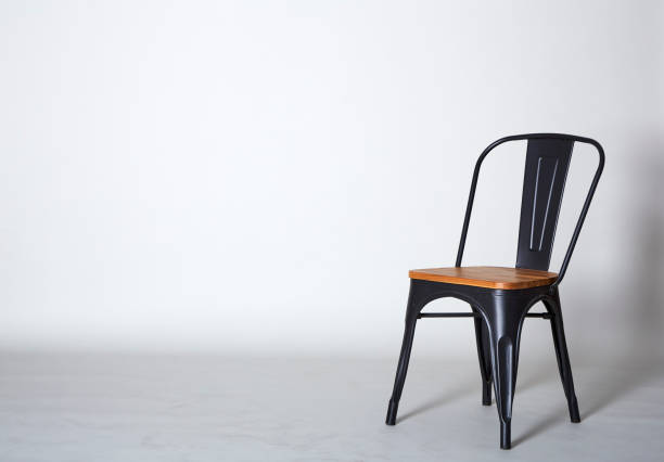istock Steel with wood chair on Grey  textured background wall 945383774