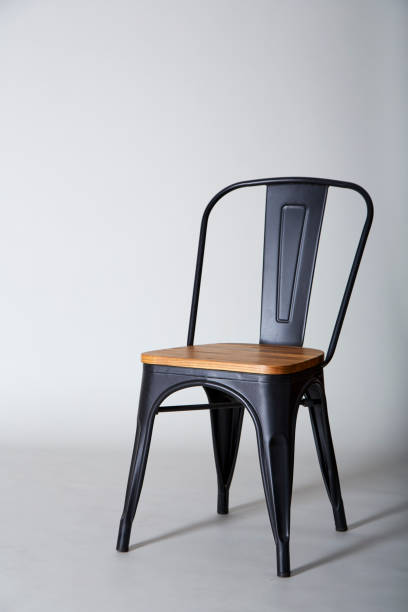 istock Steel with wood chair on Grey  textured background wall 945383778