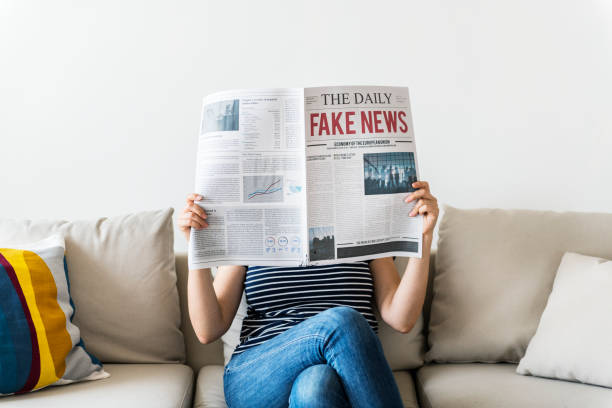istock Woman reading newspaper on a couch 945384158