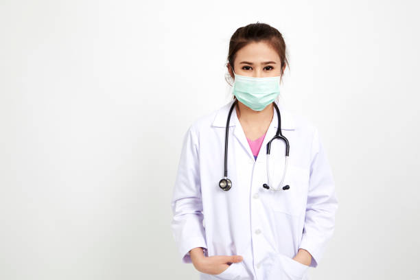 istock Cheerful happy doctor stethoscope with mask on white background 945384594