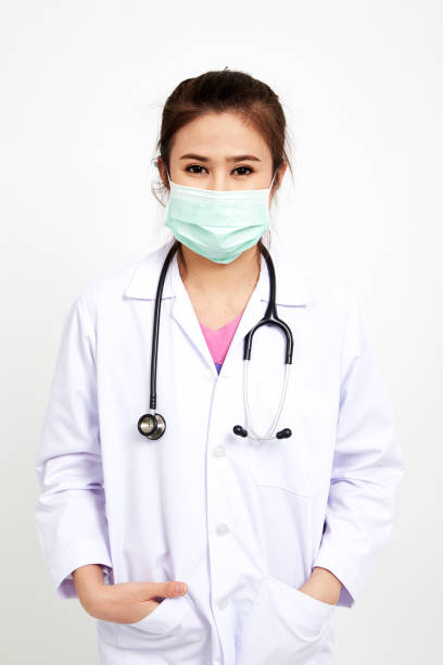 istock Cheerful happy doctor stethoscope with mask on white background 945384606