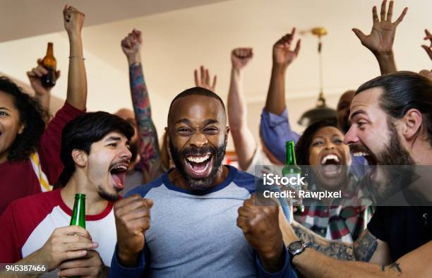 Friends Cheering Sport At Bar Together Stock Photo - Download Image Now - Soccer, Fan - Enthusiast, Bar - Drink Establishment