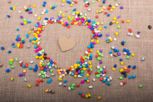 istock Paper heart in another heart form shaped by pebbles 945390546