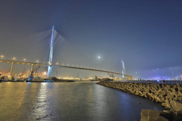 istock moon raise view at Stonecutters Bridge, Hong Kong. 945390564