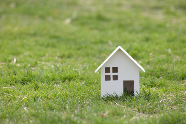 istock Paper cut of house on nature background with copy space. 945395514