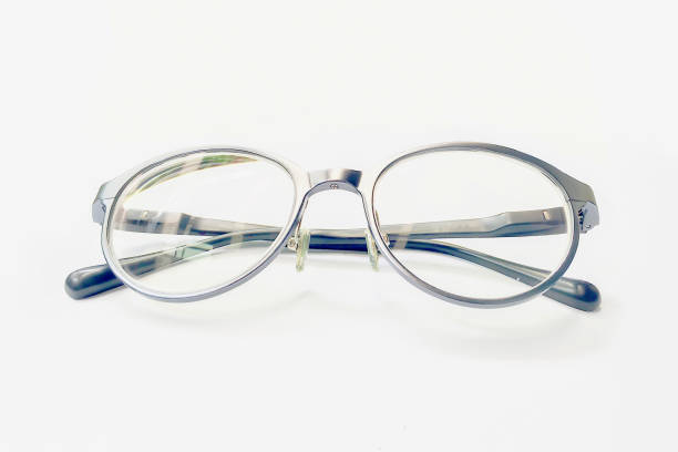 istock Closeup on Eyeglasses with bright light on white paper background. 945397988