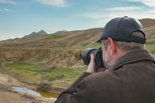 Nature photographer in mountains Nature photographer in mountains hobbyist stock pictures, royalty-free photos & images