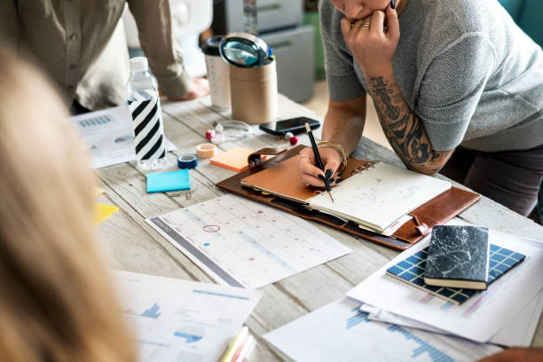 istock Tattooed woman planning a work together 945398668