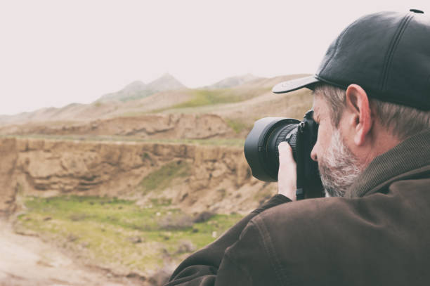 istock Nature photographer in mountains 945401570