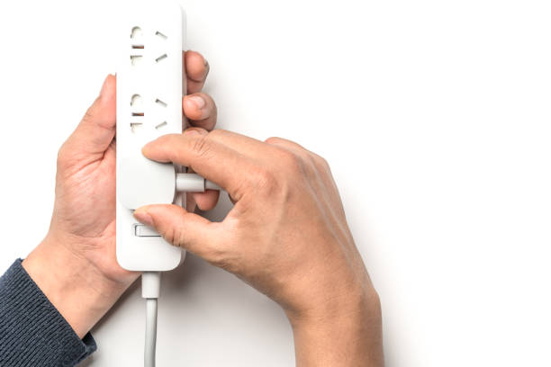 man hand plugging the electric power socket bar white color isolate. save energy and reduce energy efficiency concept - electric plug outlet human hand electricity imagens e fotografias de stock