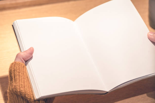 istock women reading a book on her hand, blank book holding for copy space, education concept 945405088