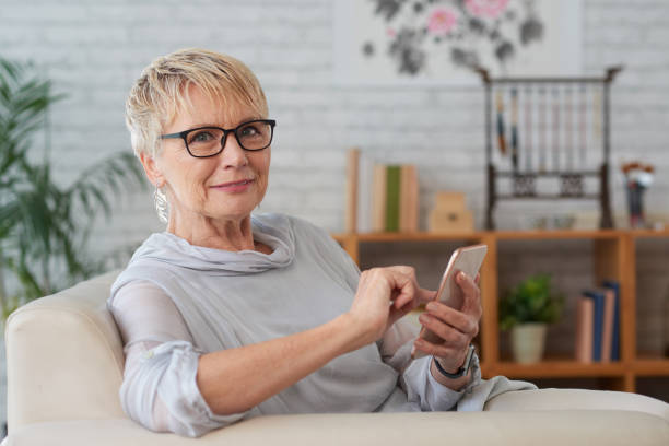 istock Aged woman with smartphone 945408994