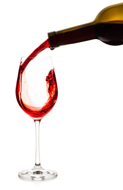 istock Red wine pouring into wine glass 945409412