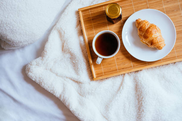 istock Coffee and croissant in bed 945410092