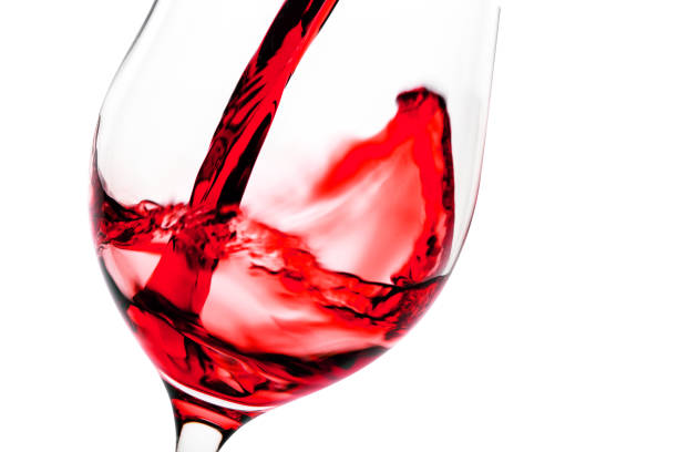 istock Red wine pouring in glass goblet 945415756