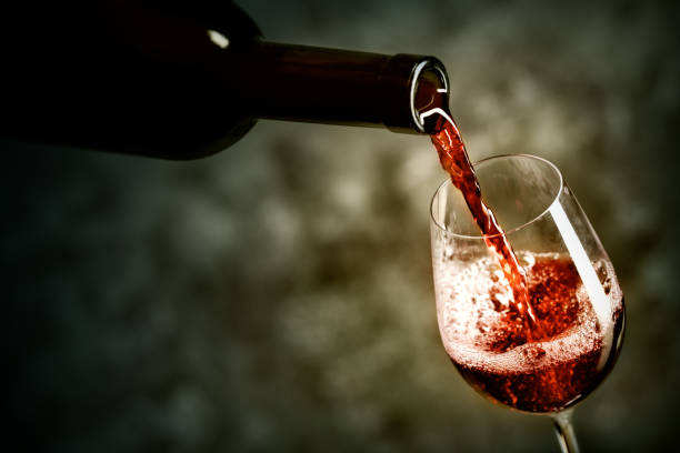 istock Red wine is being poured into the glass 945416290