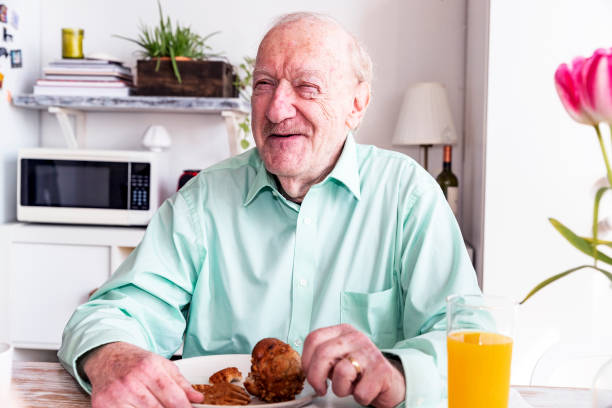 istock Joyful grandfather having a large breakfast 945420236