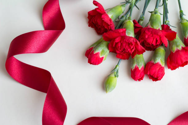 istock Red Carnation Flower and Red Ribbon Mother's Day Image 945420442
