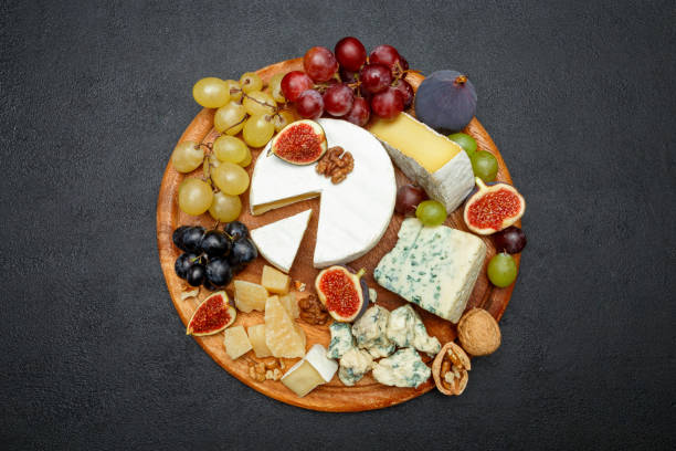 istock Brie cheese on a wooden Board with fresh figs and grapes 945420492