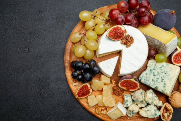 istock Brie cheese on a wooden Board with fresh figs and grapes 945420530