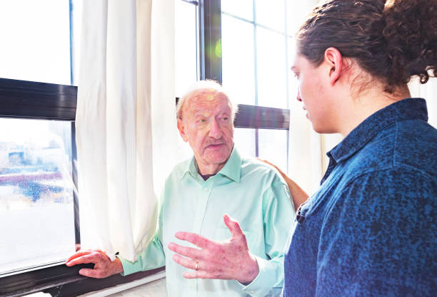 istock Grandfather talking to his grandson at home 945420768