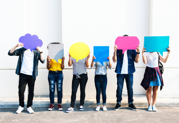 Young adult friends holding up copy space placard thought bubbles Young adult friends holding up copy space placard thought bubbles gen z stock pictures, royalty-free photos & images