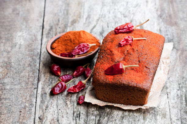 istock Delicious  chocolate cake with chili pepper on black stone background 945424190