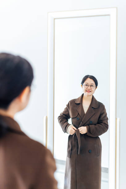 istock Beautiful woman dressed in front of mirror 945425170