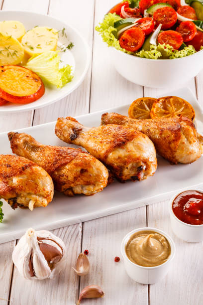 istock Barbecued chicken drumstick with vegetables 945426226
