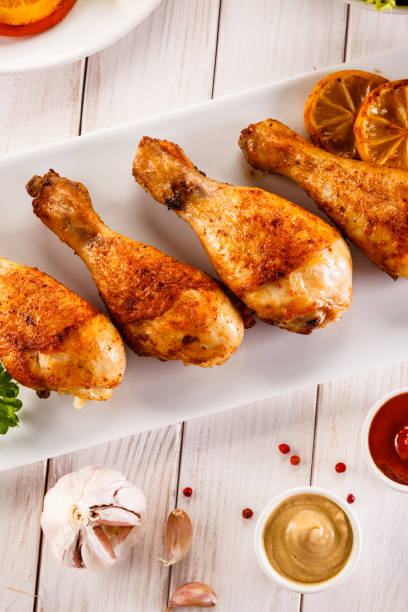 istock Barbecued chicken drumstick with vegetables 945427244