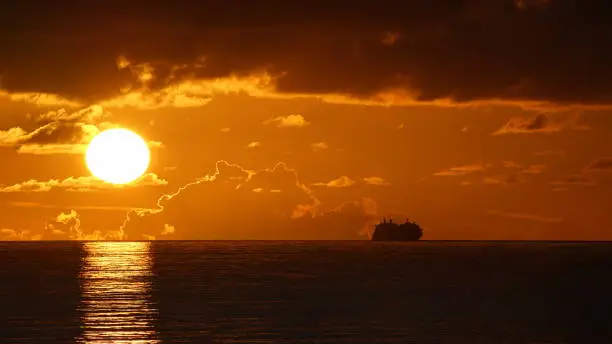 Photograph of the Celebrity Equinox Cruise Ship at sunset in the North Atlantic Ocean off of the Greater Antilles Islands near the Caribbean Sea. Taken from MSC Seaside 4/5/2018.