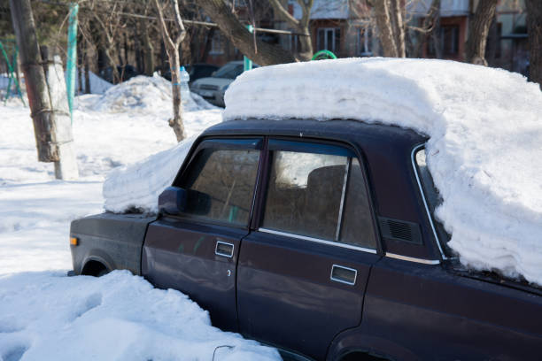 istock Old abandoned car covered with several layers of snow 945430642