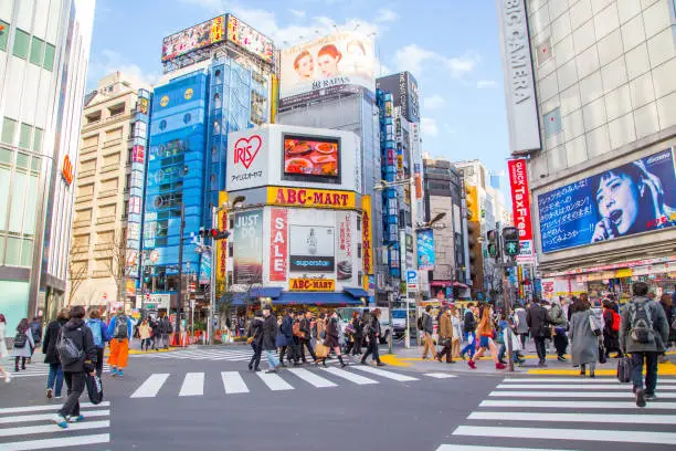 Tokyo, Japan, March 3, 2016: City street with crowd people on zebra crosswalk in Shinjuku town. Shinjuku is a special ward located in Tokyo for shopping