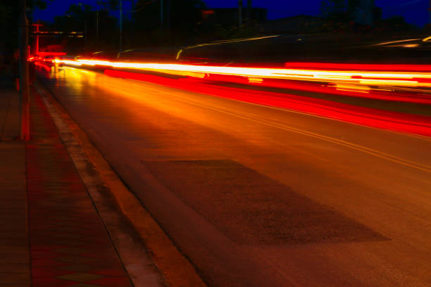 istock car lights at night in city and headlights. Long exposure with copy space add text 945431794