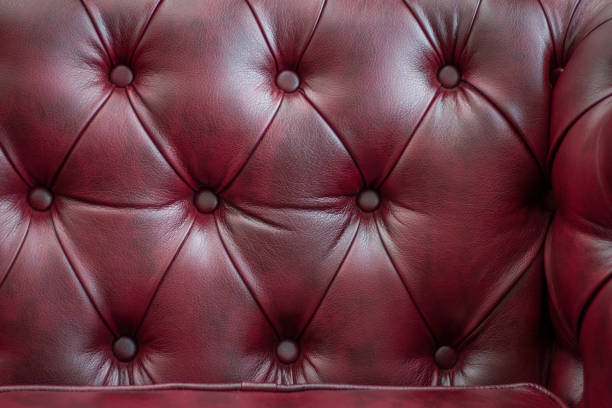 istock Closeup texture of vintage red leather sofa for background 945434440