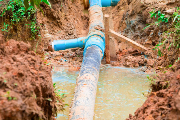 istock repair plumbing PVC broken pipe in hole which has water with copy space add text 945434544